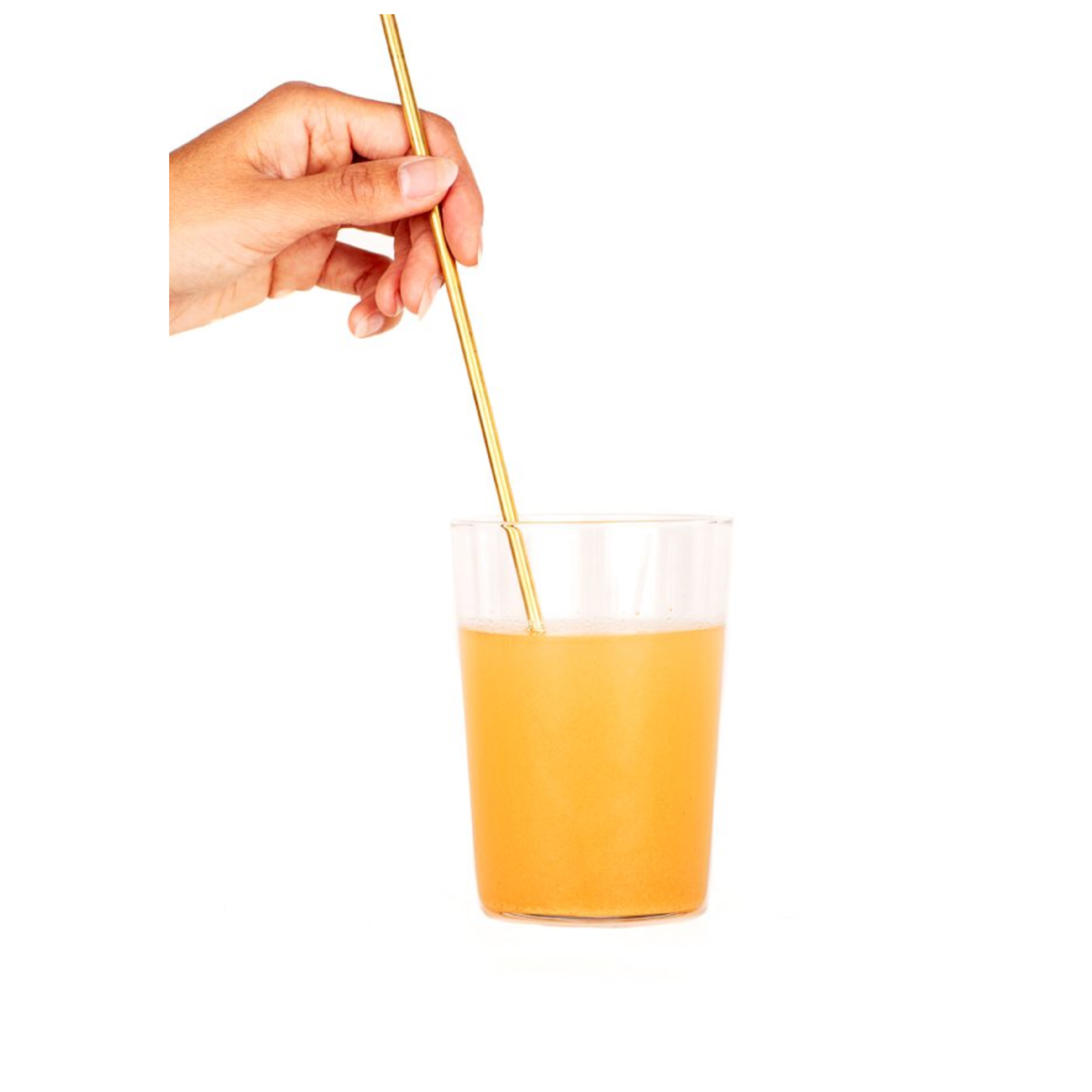 turmeric extract in a glass being hand stirred with a stick